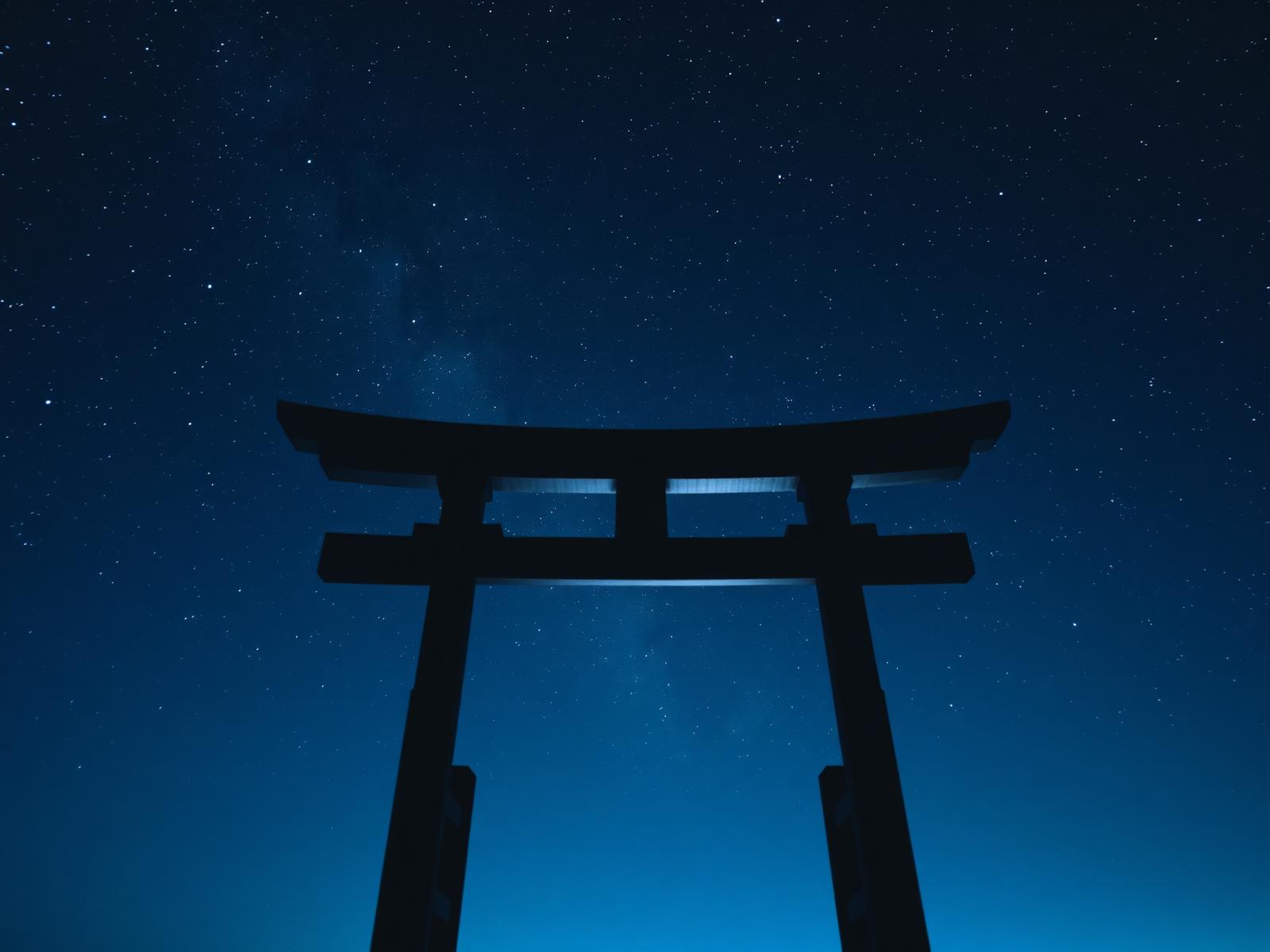 Torii gate beneath a starry sky